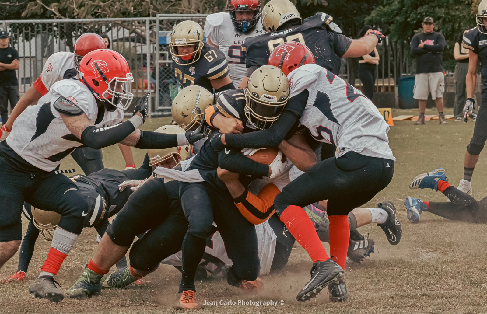 Alajuela Pumas defense making a group tackle