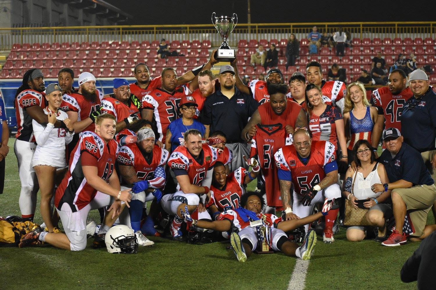 Team USA celebrating together with the championship trophy