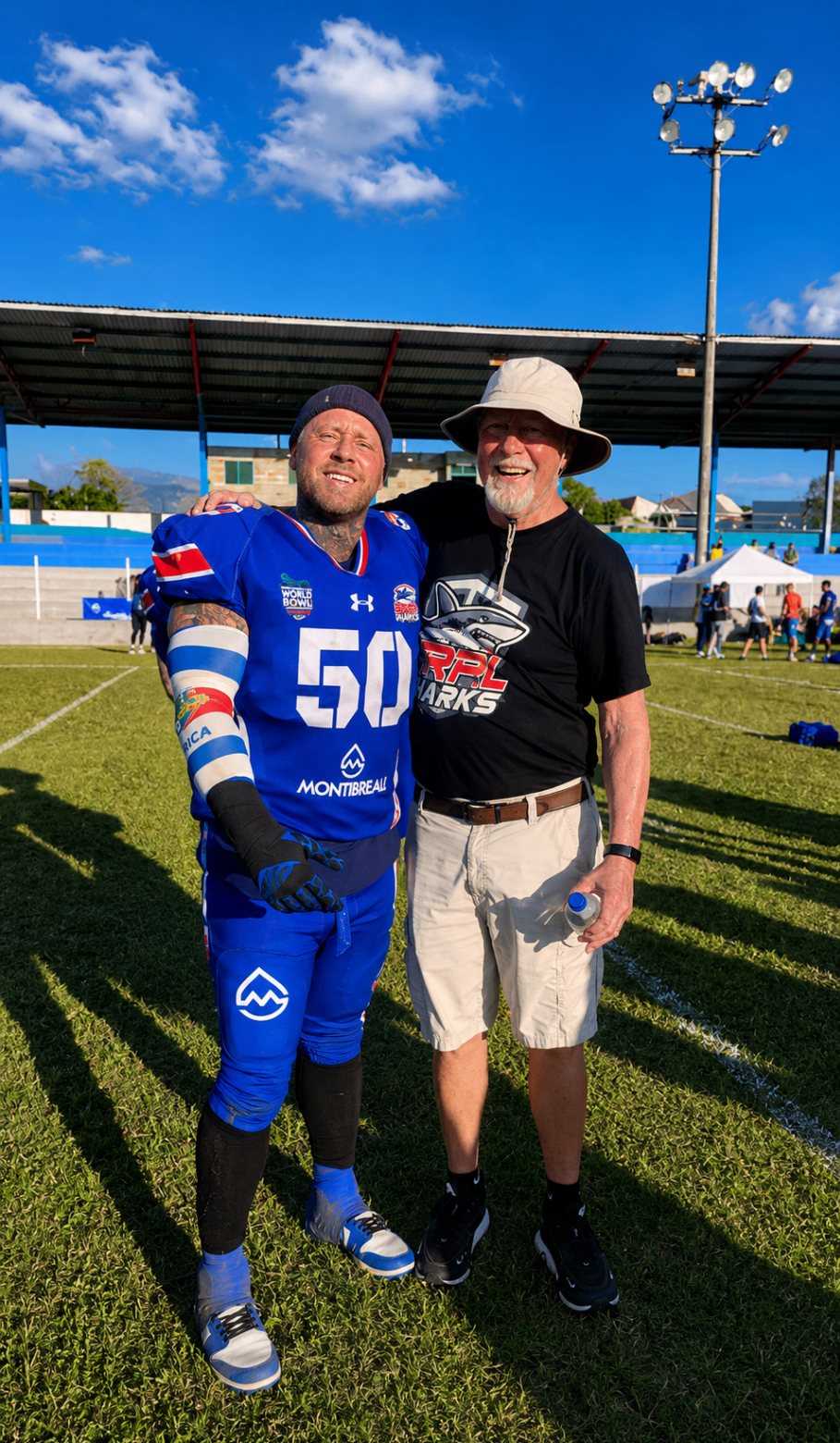 Ian and a supporter embracing after the game in Greece