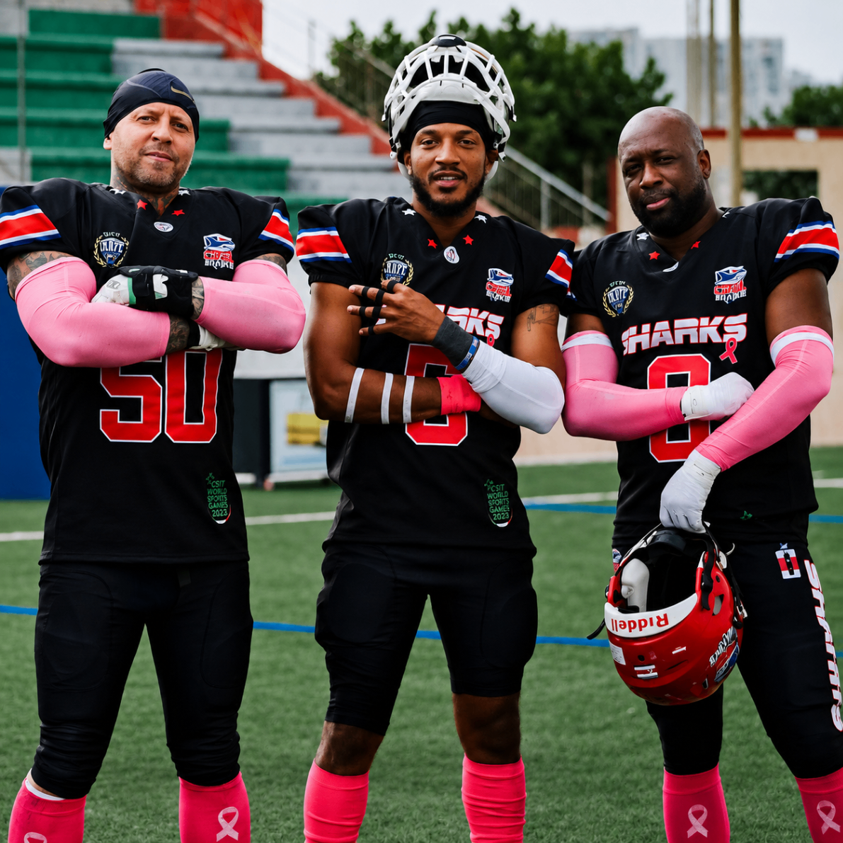 Three Costa Rica Sharks players in black uniforms supporting breast cancer awareness