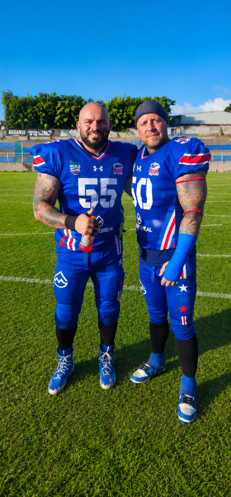 Two Costa Rica Sharks teammates standing together in blue uniforms
