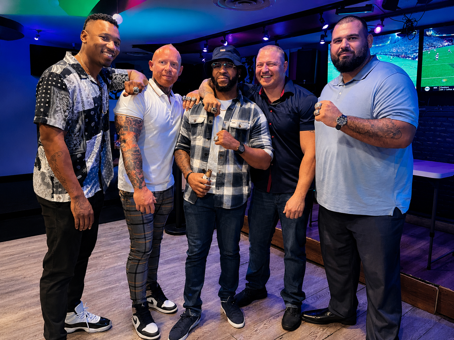 The core group together showing their championship rings