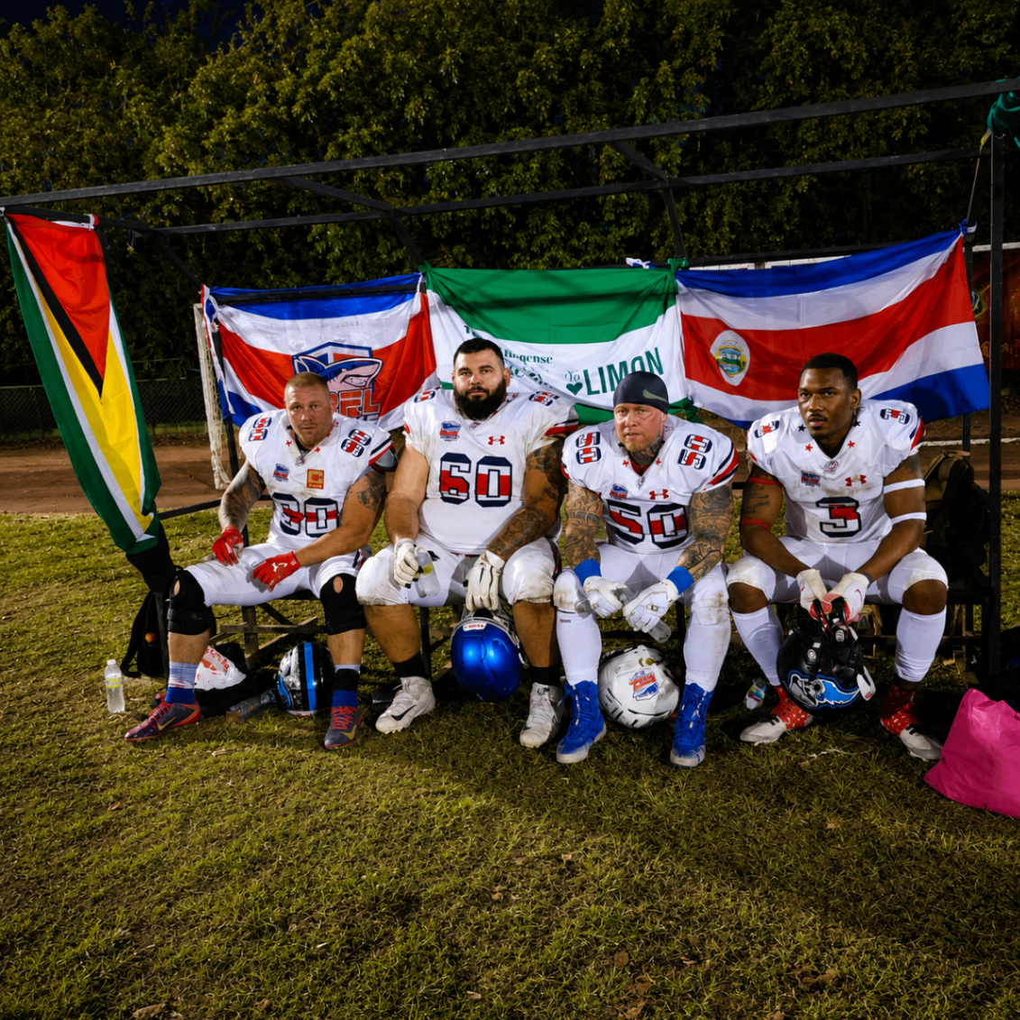 Costa Rica Sharks players seated beneath international flags