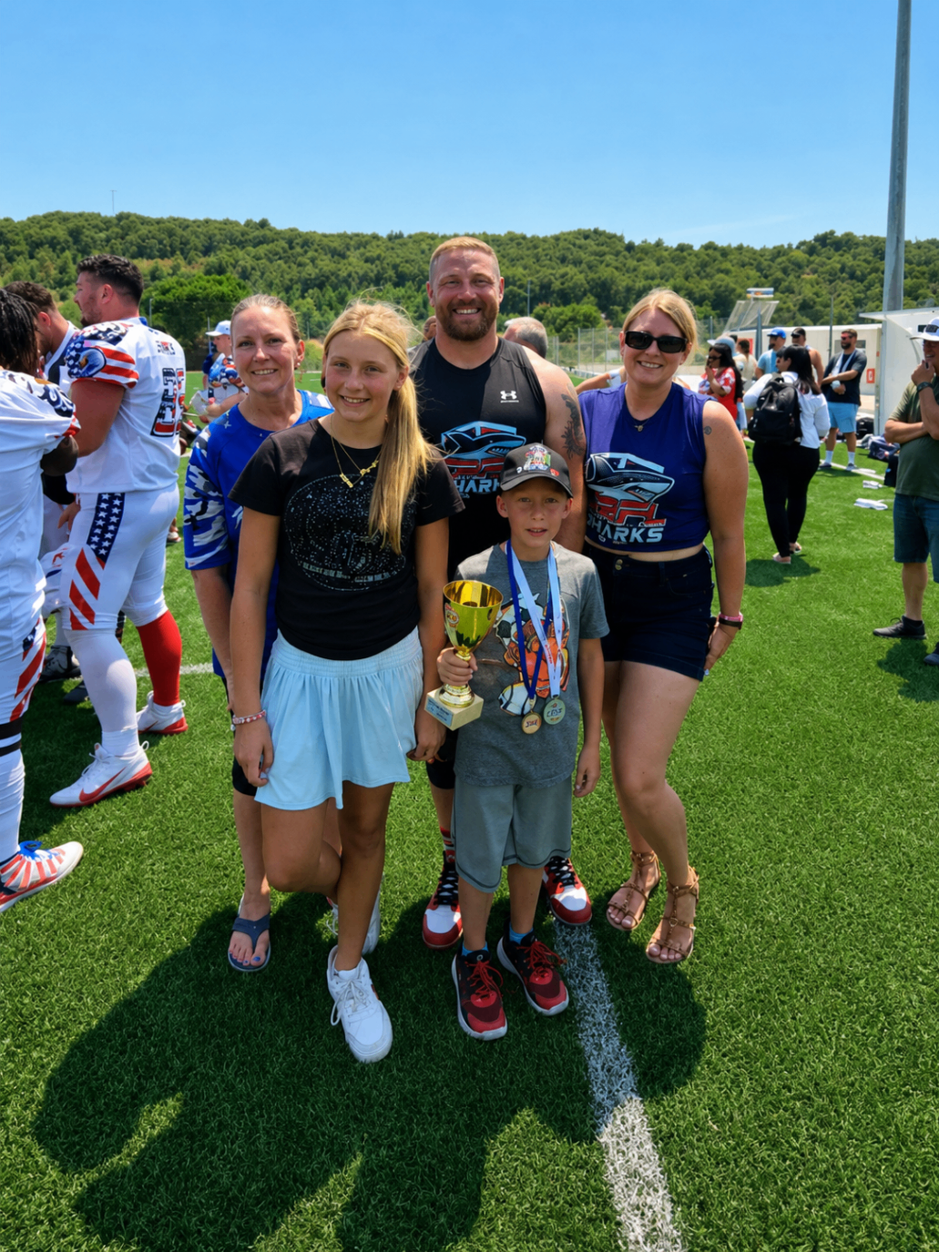 Karl surrounded by family and supporters on the field in Greece