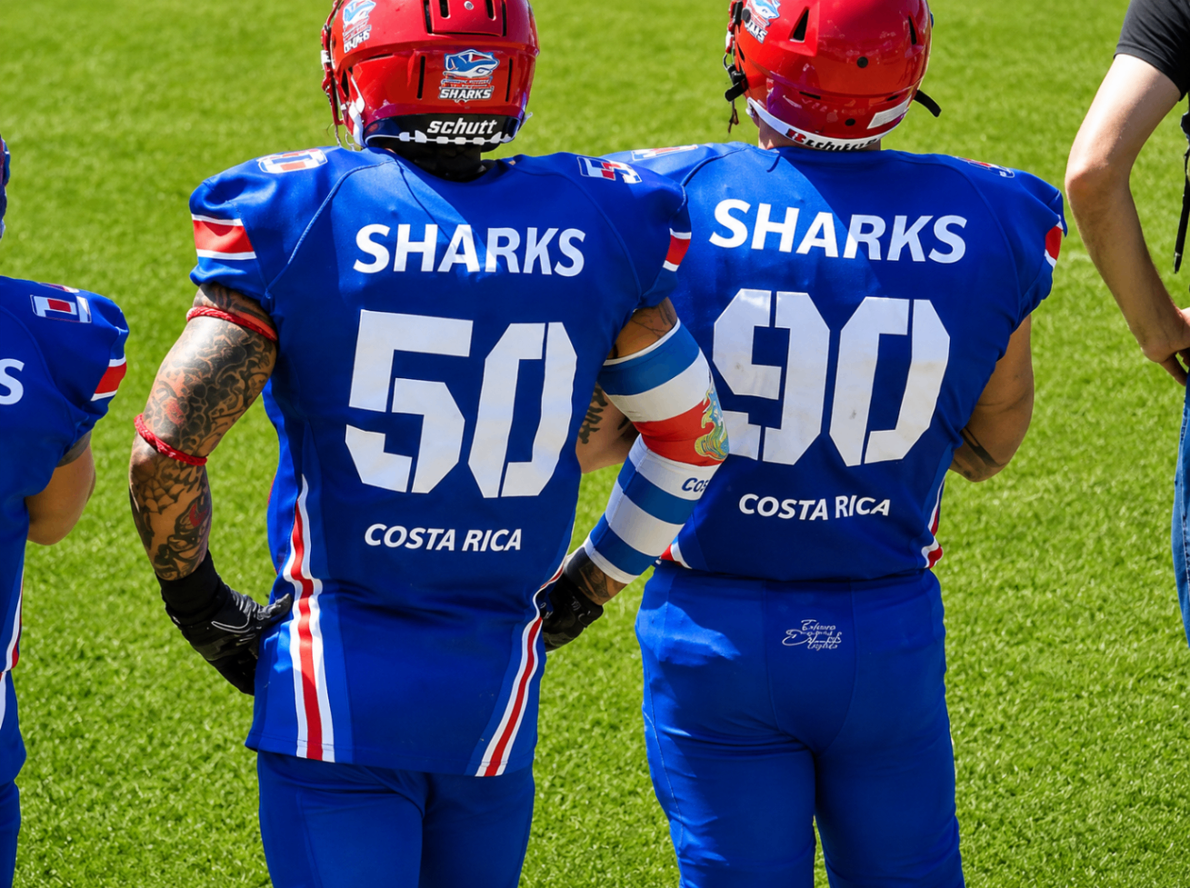 Costa Rica Sharks teammates number 50 and 90 standing together on the sideline