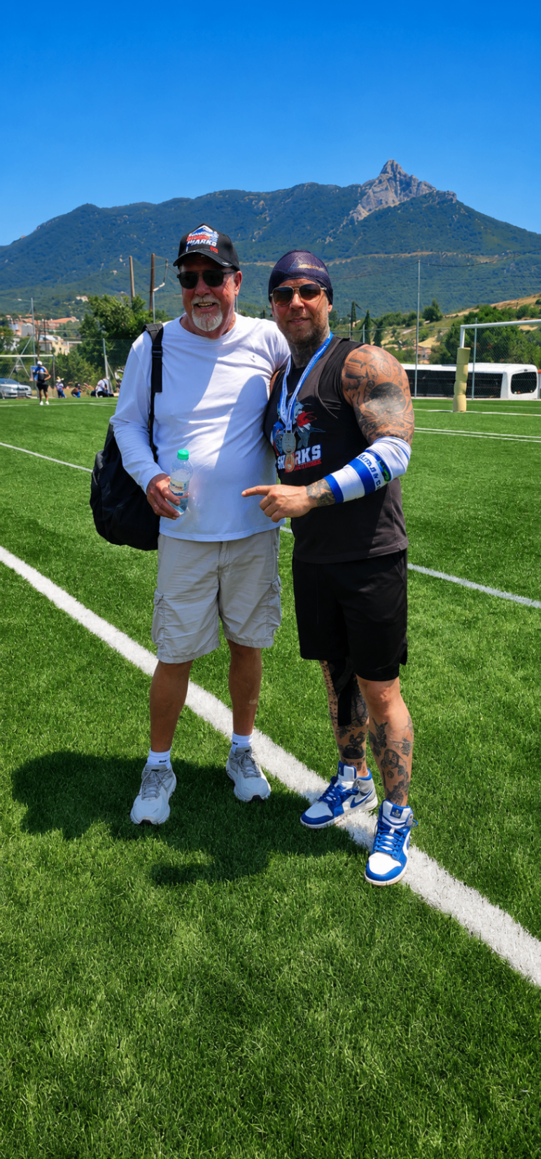 Ian and a supporter together on the football field in Greece