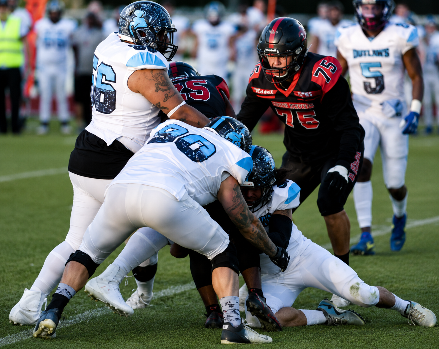 Intense game action with Outlaws players making a tackle