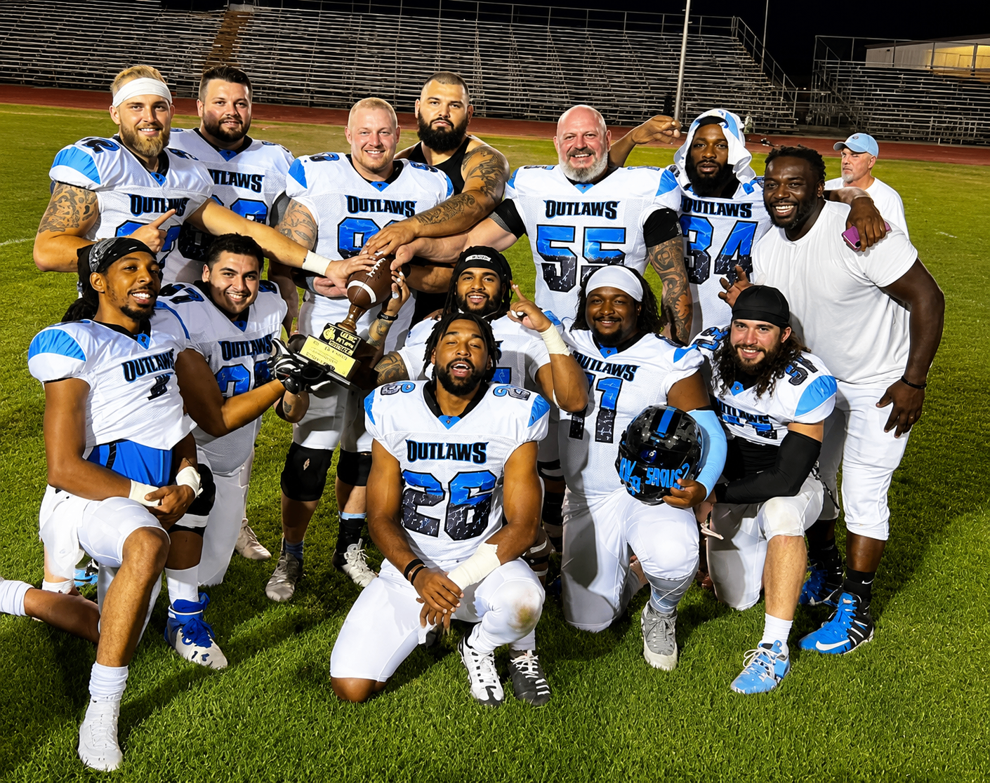 Phoenix Outlaws teammates celebrating together with the trophy