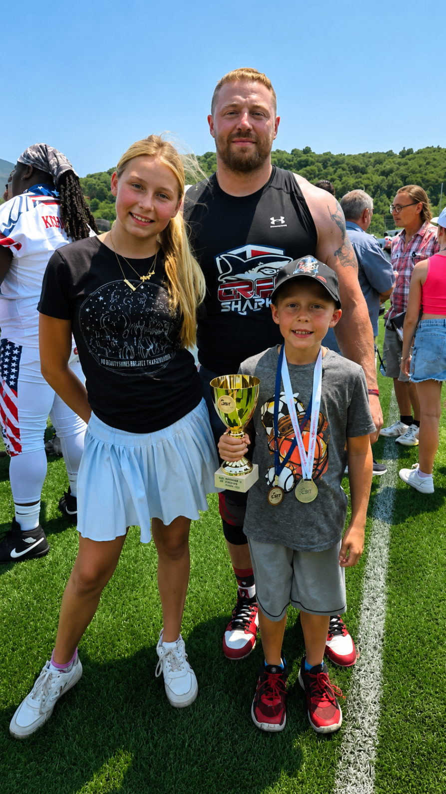 Karl with two young supporters celebrating after the championship game