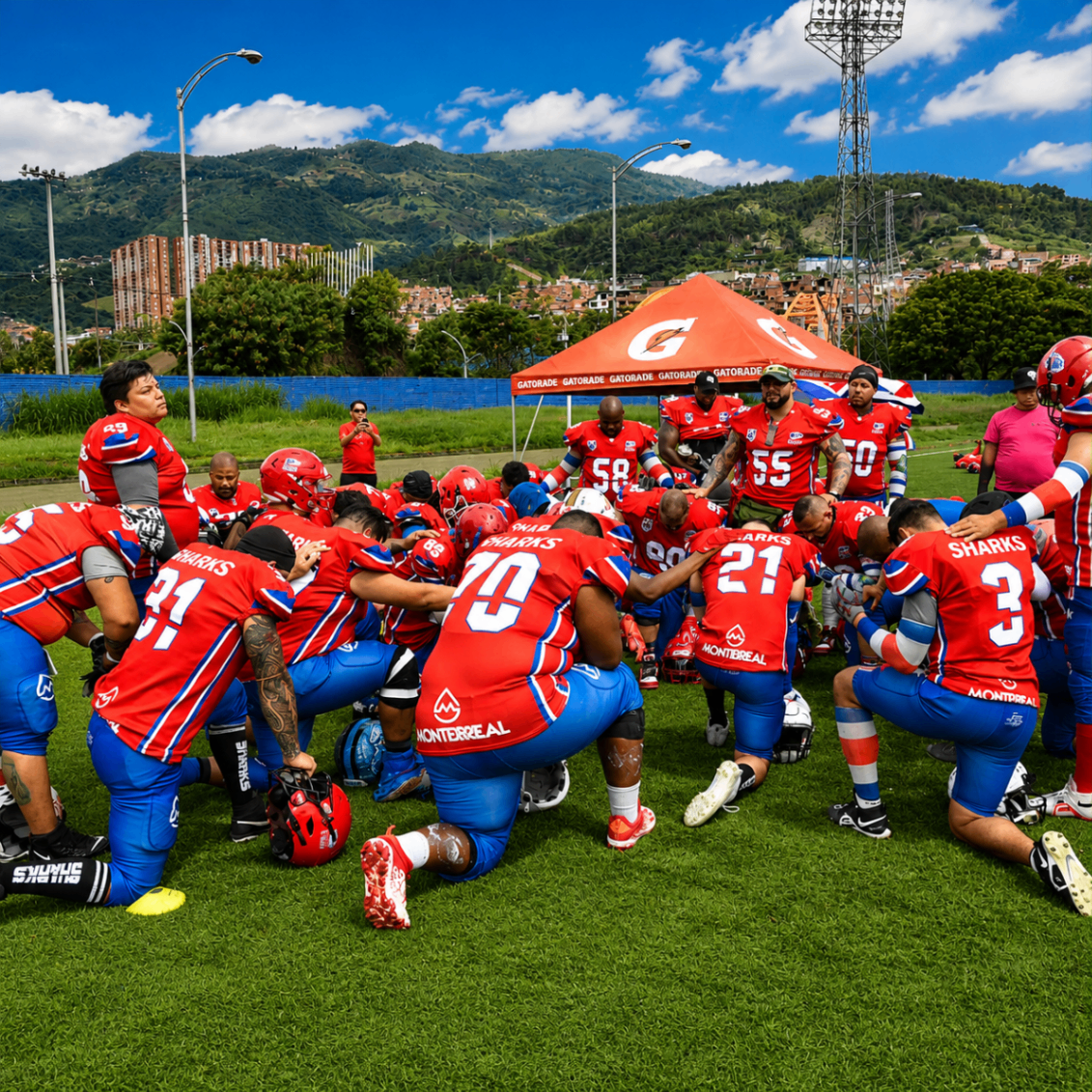 Costa Rica Sharks kneeling together before a game beneath the mountains